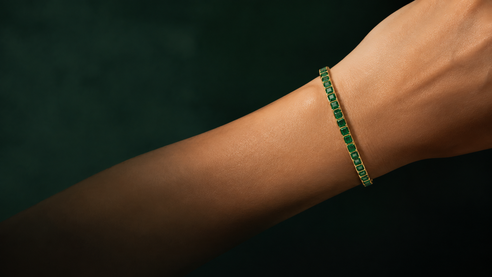 Dainty gold plated tennis bracelet on a wrist