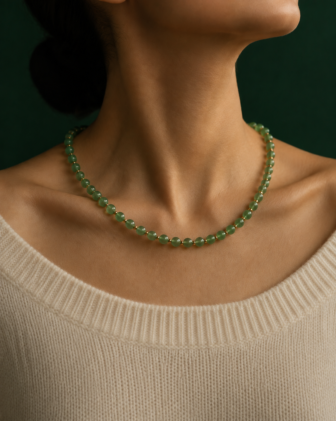 Dainty gold necklace worn alone at the collarbone