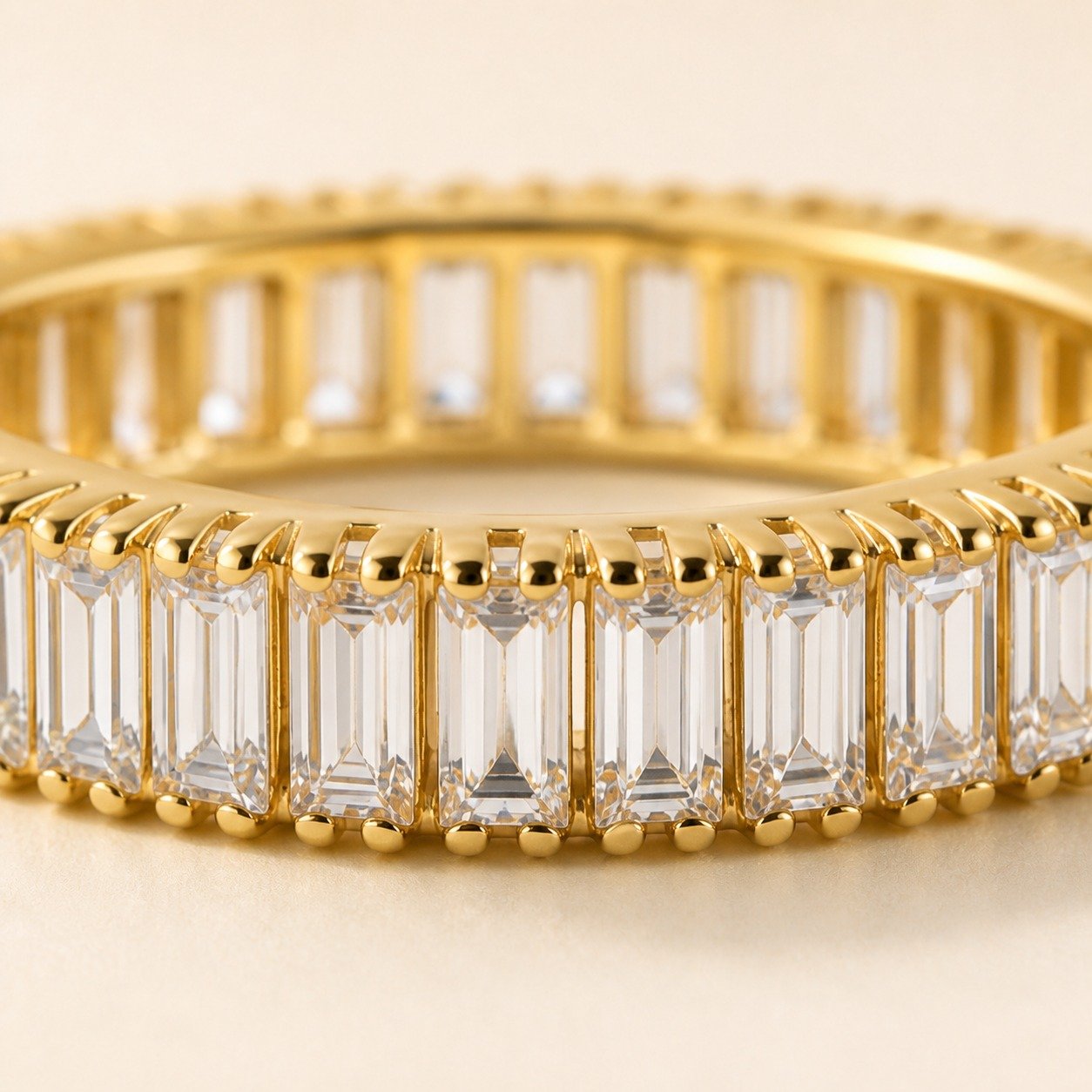 Close-up of baguette CZ eternity ring in 18K gold-plated finish
