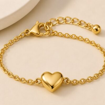 Close-up of dainty heart charm bracelet in 18K gold-plated finish